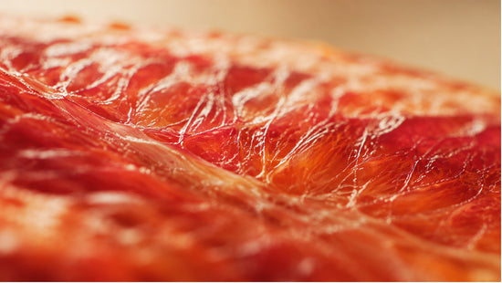 Extreme close-up abstract photograph of citrus membrane texture with warm lighting, representing CoQ10's role in supporting cellular energy and muscle health.